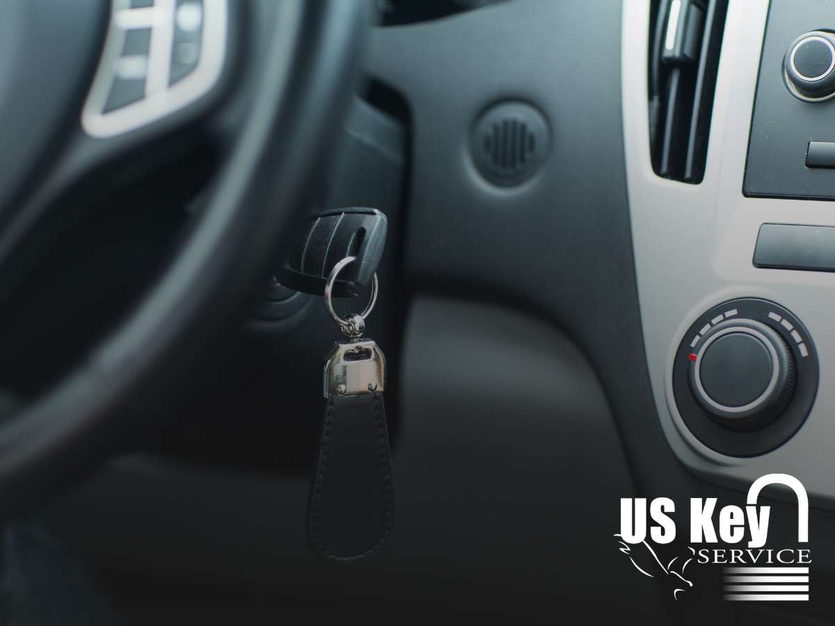 Car key in ignition with US Key Service logo, highlighting Car Key Replacement services