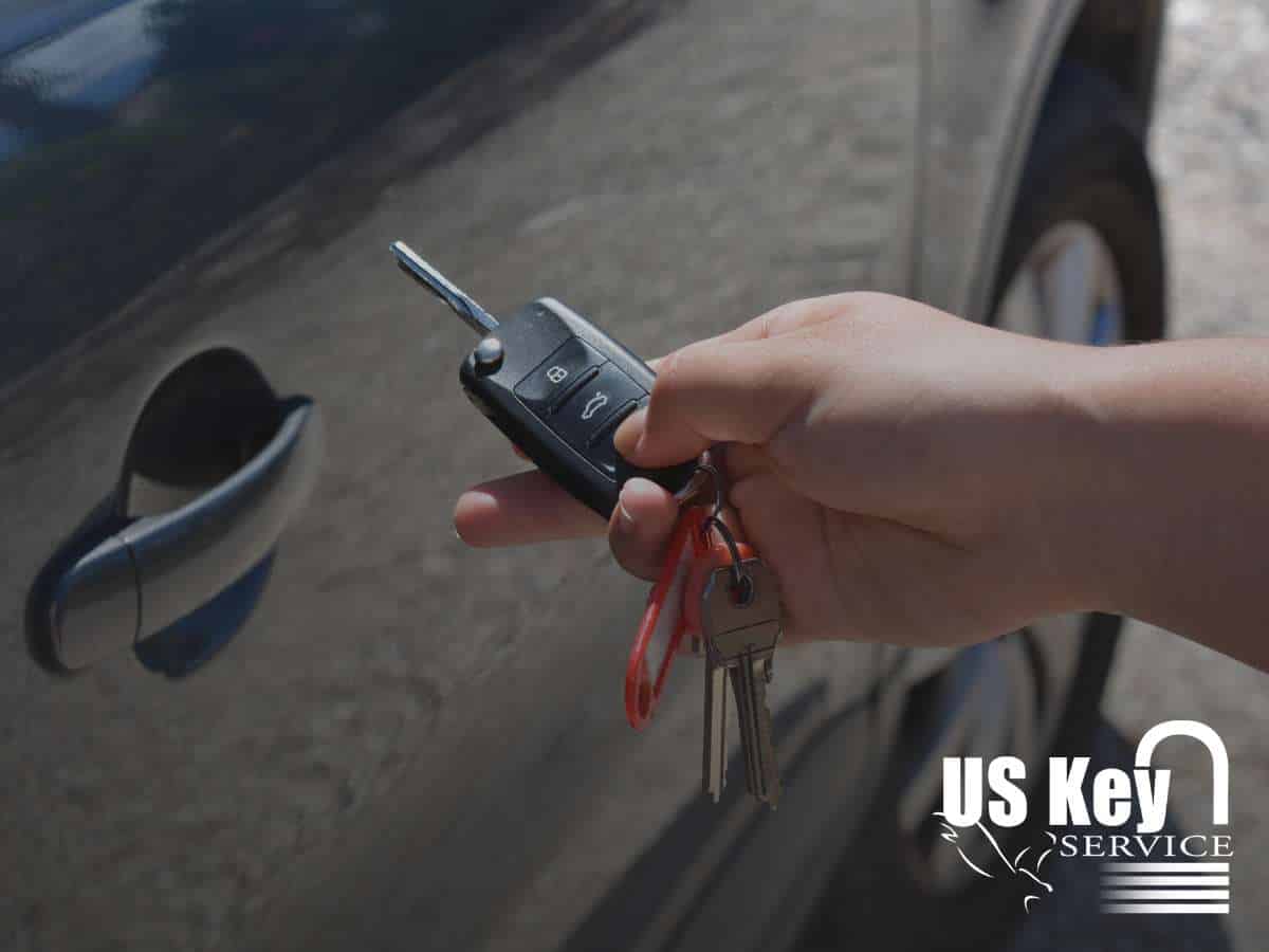 Hand holding an electronic car key near a car door, highlighting car access and security