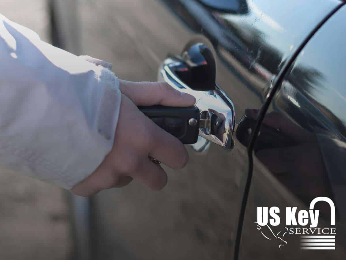 Hand using a car key to unlock a vehicle door, ensuring secure access